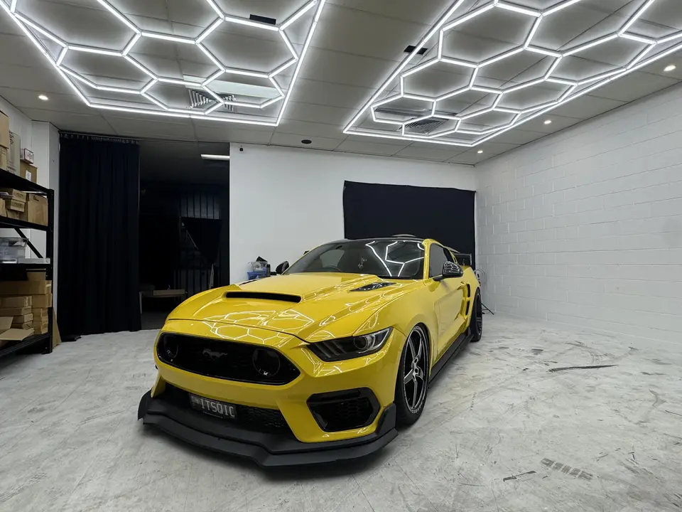 Yellow Ford Mustang in the Nerang coating studio